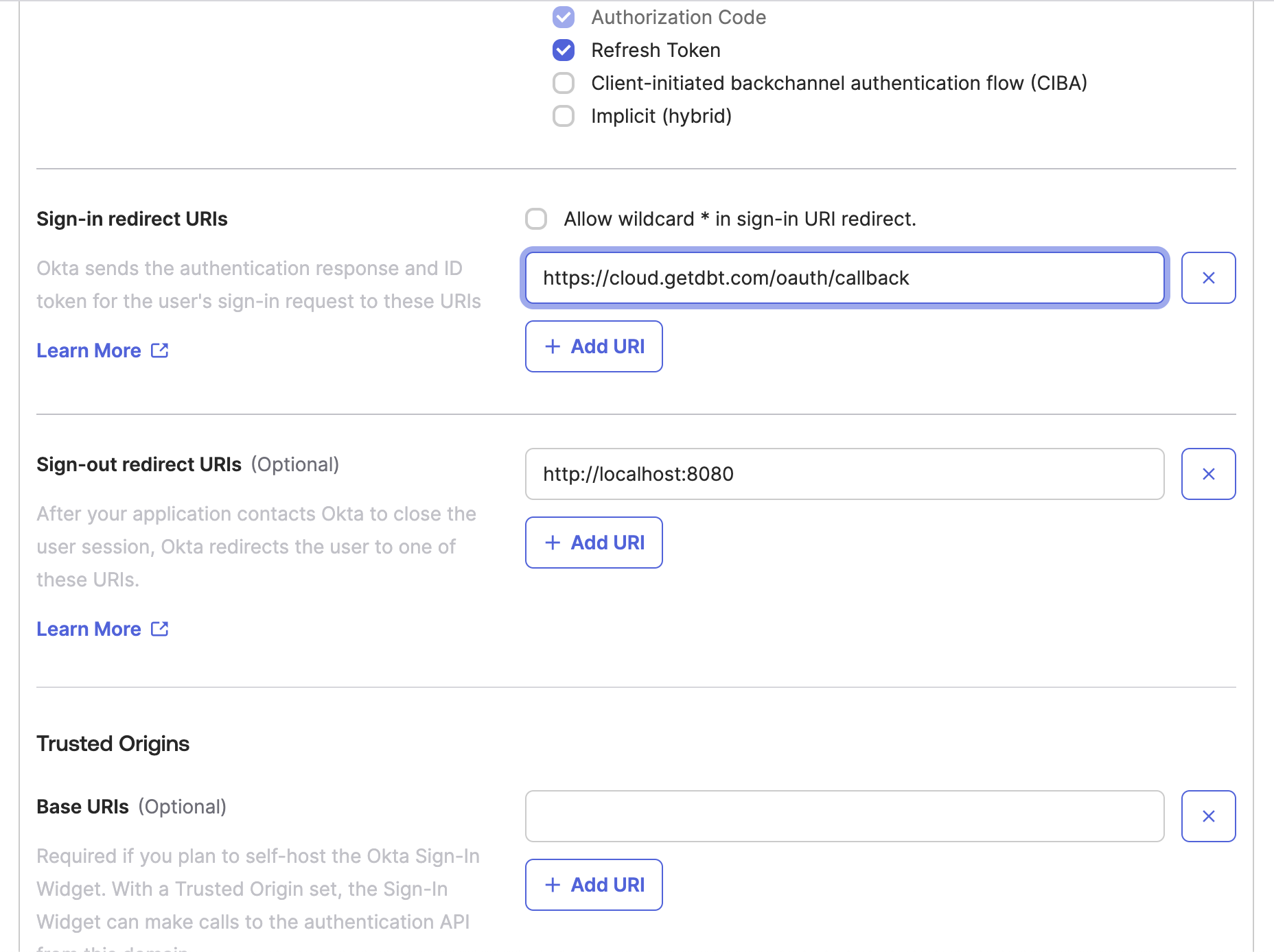 The Okta app configuration window with the sign-in redirect URI configured to the dbt value.